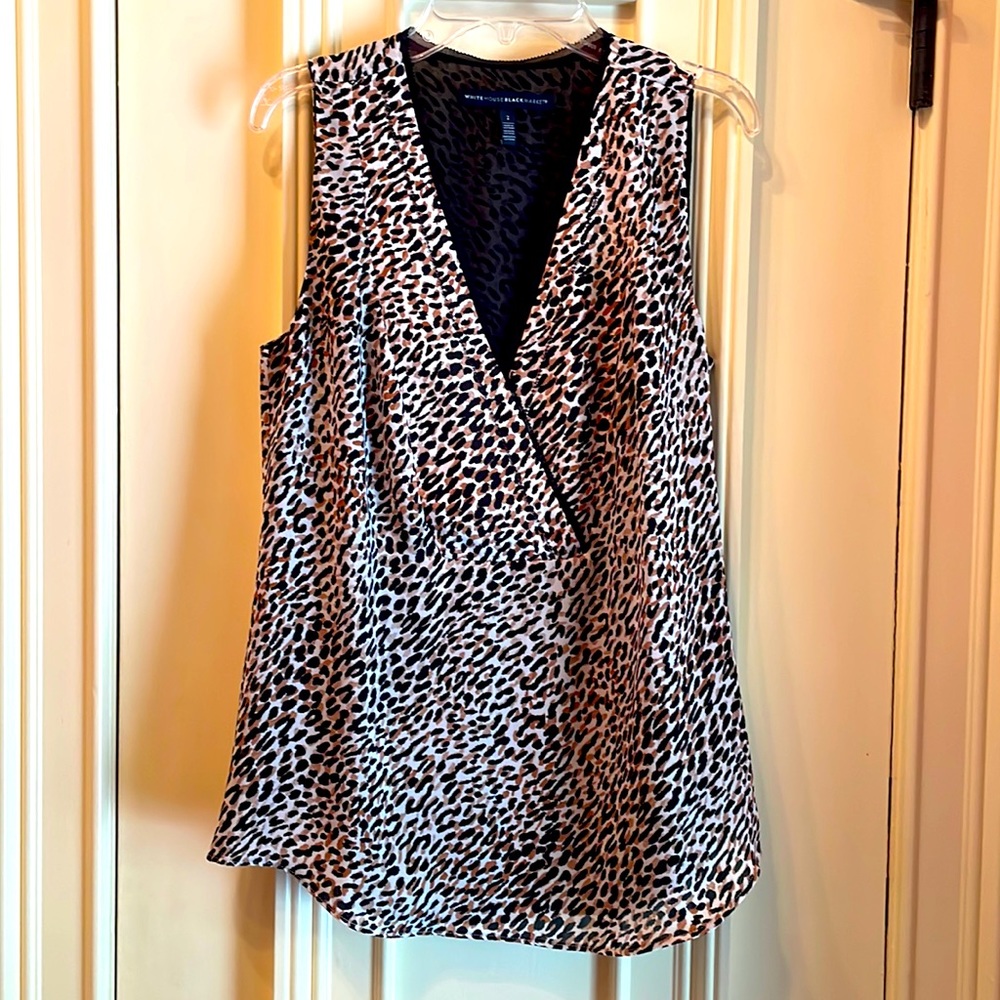 Sleeveless polyester silk sheer animal print top lined in black.